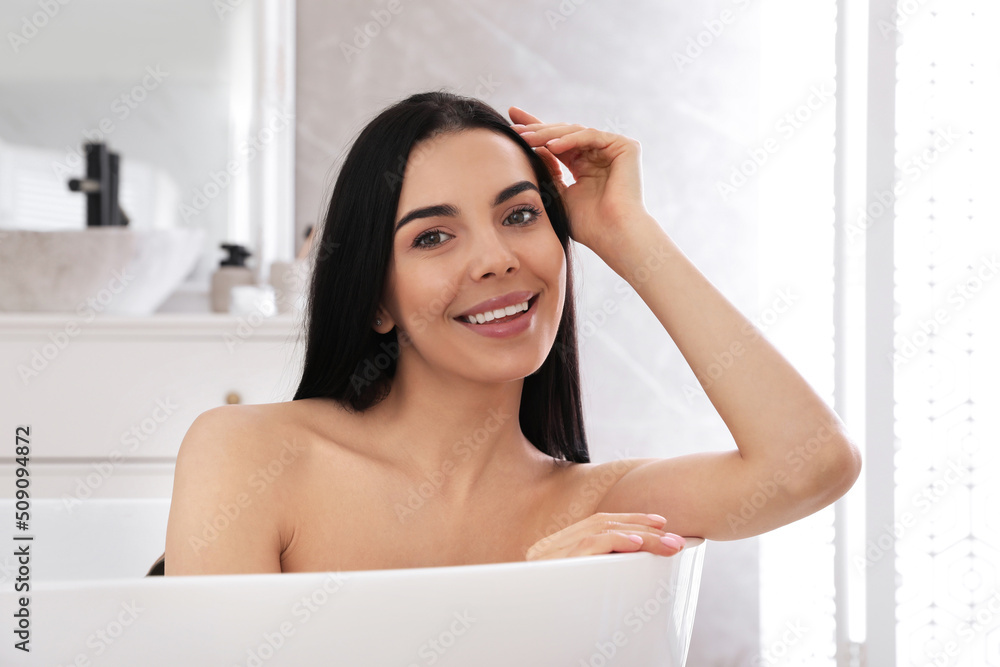 Beautiful young woman relaxing in bathtub at home Beautiful young woman relaxing in bathtub at home