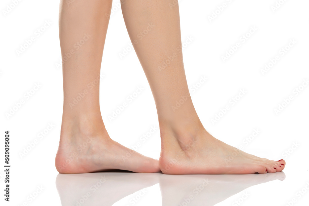 Side view of a beautifully cared female feet on a white background