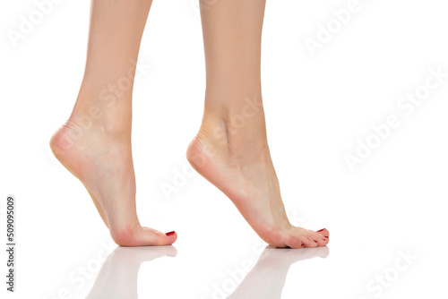Side view of a beautifully cared female feet on a white background © vladimirfloyd