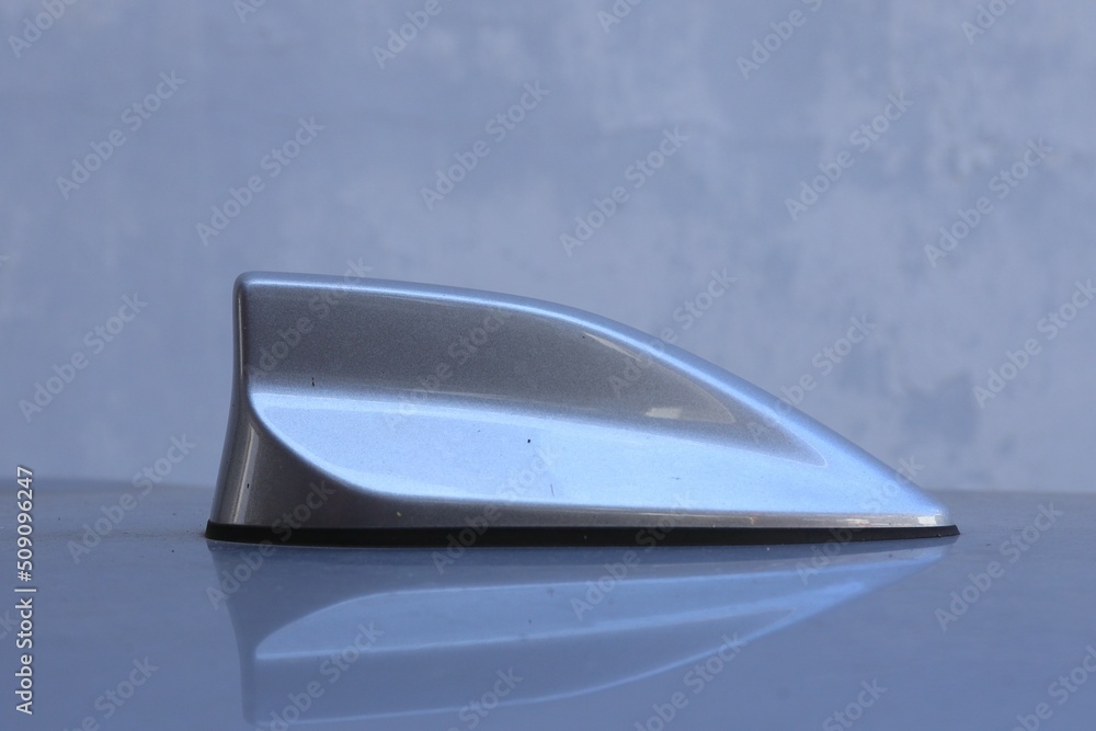 Antenna shark fin on blurry backgorund. Using automotive wallpaper or background. transport image. Antenna shark fin on blurry backgorund. Using automotive wallpaper or background. transport image.