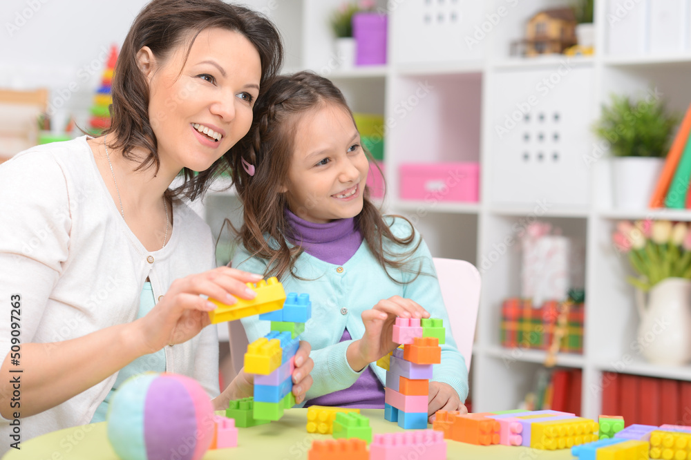 Mother and daughter playing with toys Mother and daughter playing with toys