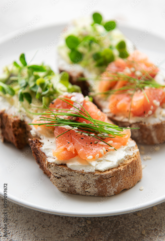 Sandwiches with salted salmon, avocado and microgreens. Sandwiches with salted salmon, avocado and microgreens.