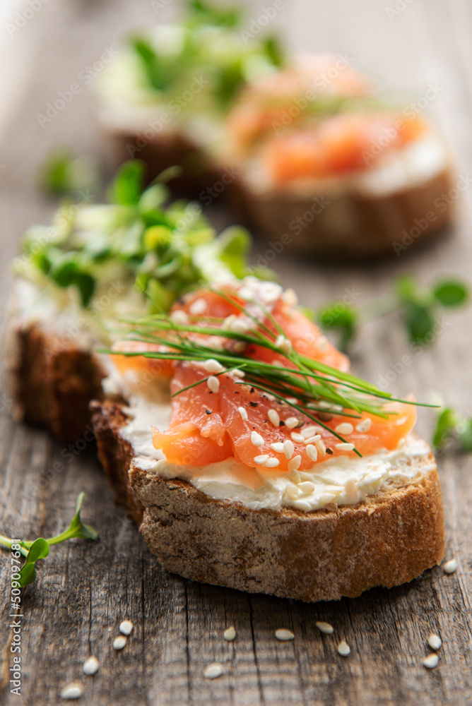 Sandwiches with salted salmon, avocado and microgreens. Sandwiches with salted salmon, avocado and microgreens.