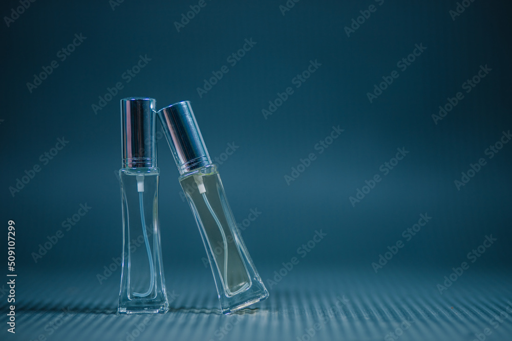 Perfume bottle on the table, blue background