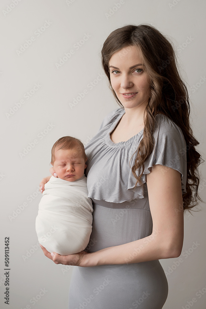 Newborn baby in mother's arms. Postcard Mother's Day. Children Protection Day. World Happiness Day. Smiling child and woman.