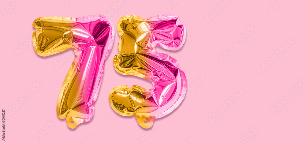 Rainbow foil balloon number, digit seventy five on a pink background. Birthday greeting card with inscription 75. Anniversary concept. Numerical digit. Celebration event, template. Banner