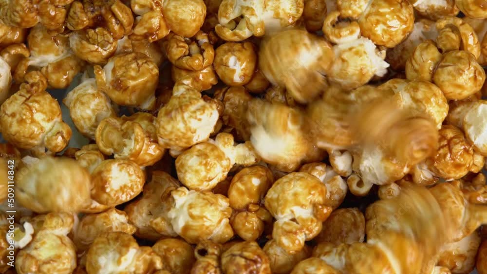 Coffee taste popcorn falls close up. Caramel popcorn. Healthy food for morning breakfast. Healthy breakfast concept. High quality 4k footage Coffee taste popcorn falls close up. Caramel popcorn. Healthy food for morning breakfast. Healthy breakfast concept. High quality 4k footage
