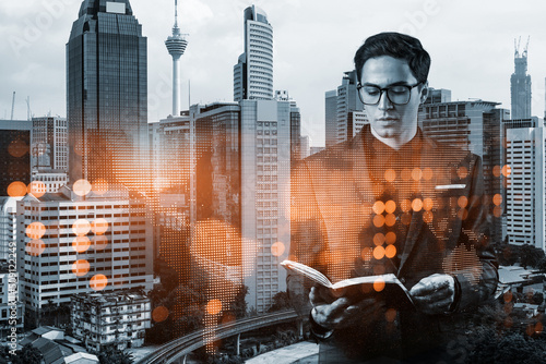 Canvas Print Handsome eastern HR director at international company is looking into personal organizer to plan business meeting to recruit highly qualified specialists