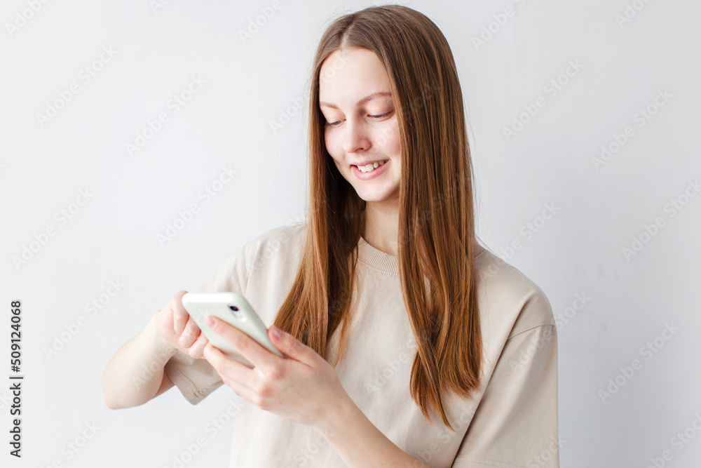 teen girl looking at screen of phone teen girl looking at screen of phone