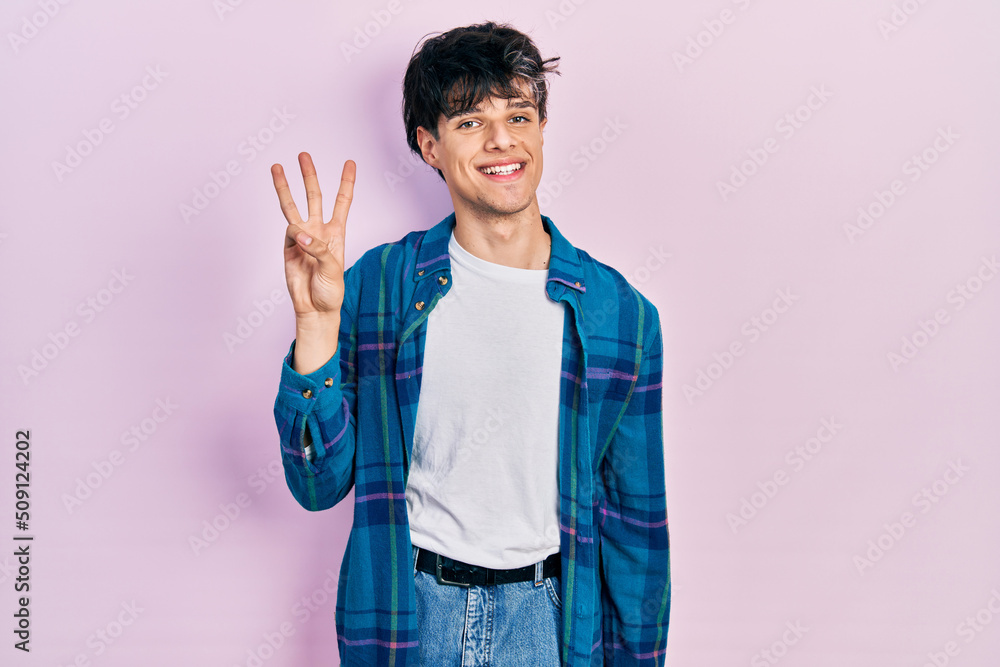 Handsome hipster young man wearing casual white t shirt and vintage shirt showing and pointing up with fingers number three while smiling confident and happy. Handsome hipster young man wearing casual white t shirt and vintage shirt showing and pointing up with fingers number three while smiling confident and happy.