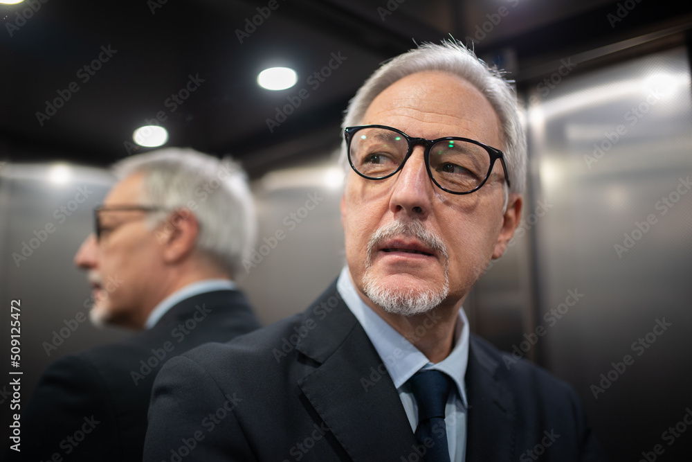 Businessman inside an elevator Businessman inside an elevator