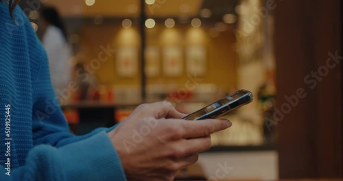 Wallpaper Mural Close up profile side view on young woman, teen hands holding mobile phone, using smartphone, typing message, chatting with friends on social media, sitting outdoors in city cafe on weekend, day off Torontodigital.ca