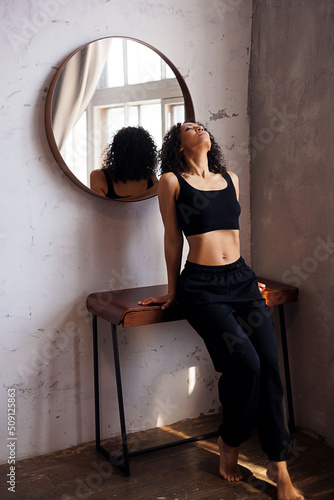 Sexy woman posing. Portrait of young curly girl 