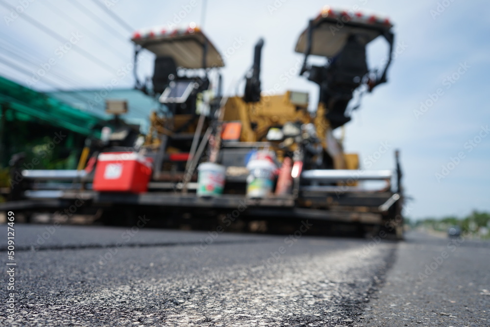 The image is blurred in the construction of asphalt road.