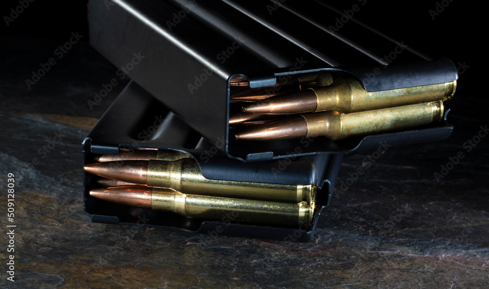 Fototapeta premium Two metal magazines loaded with ammo