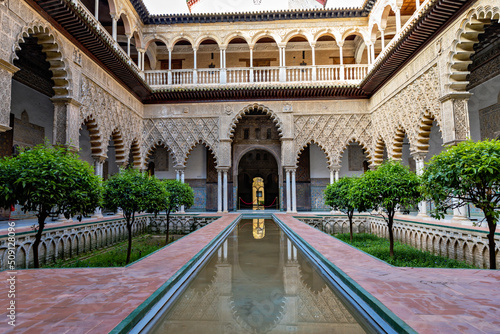 Beautiful formal public garden inside Alcazar Seville palace in summertime in Andalusia