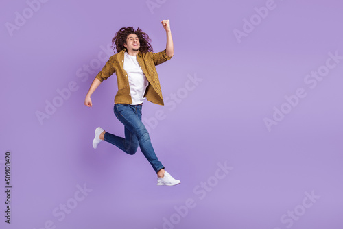 Full body profile side photo of young man go walk run hurry discount isolated over purple color background