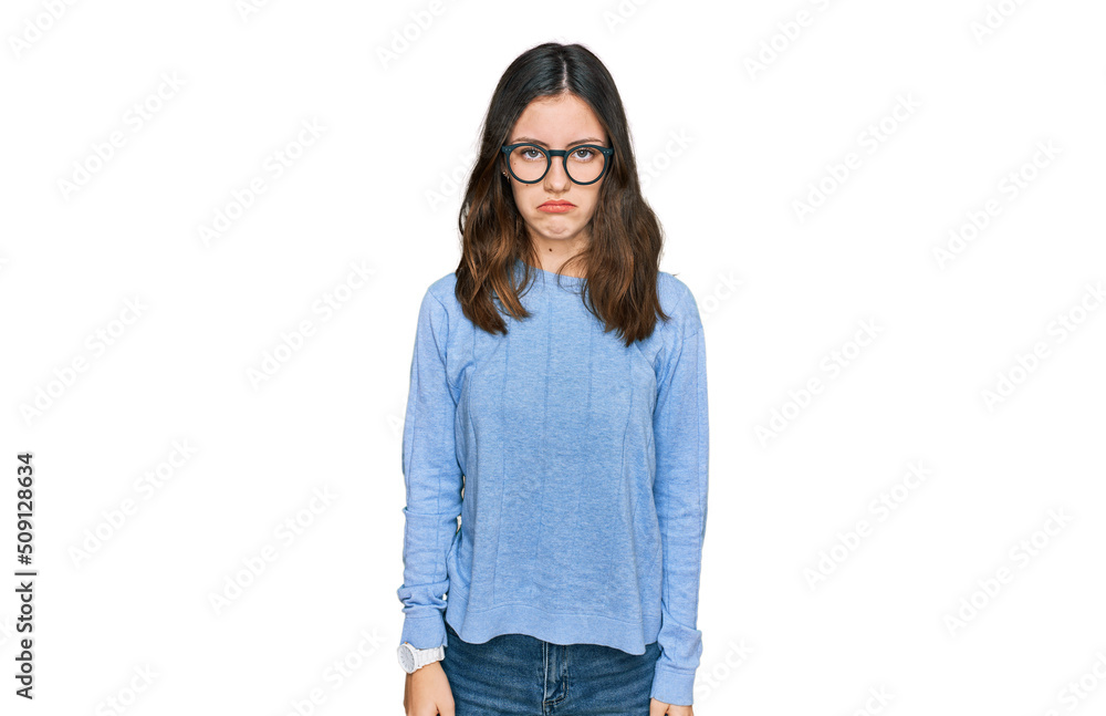 Young beautiful woman wearing casual clothes and glasses depressed and worry for distress, crying angry and afraid. sad expression. Young beautiful woman wearing casual clothes and glasses depressed and worry for distress, crying angry and afraid. sad expression.