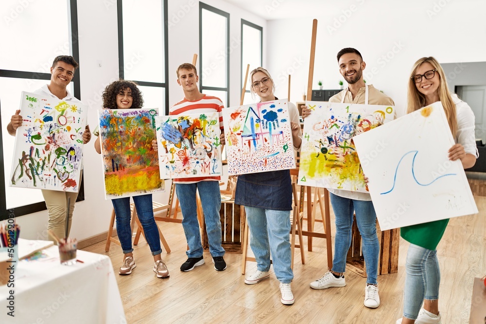 Fototapeta premium Group of people smiling happy canvas with draw standing at art studio.