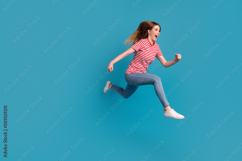 Full size profile side photo of young excited woman run rush discount wear casual outfit isolated over blue color background