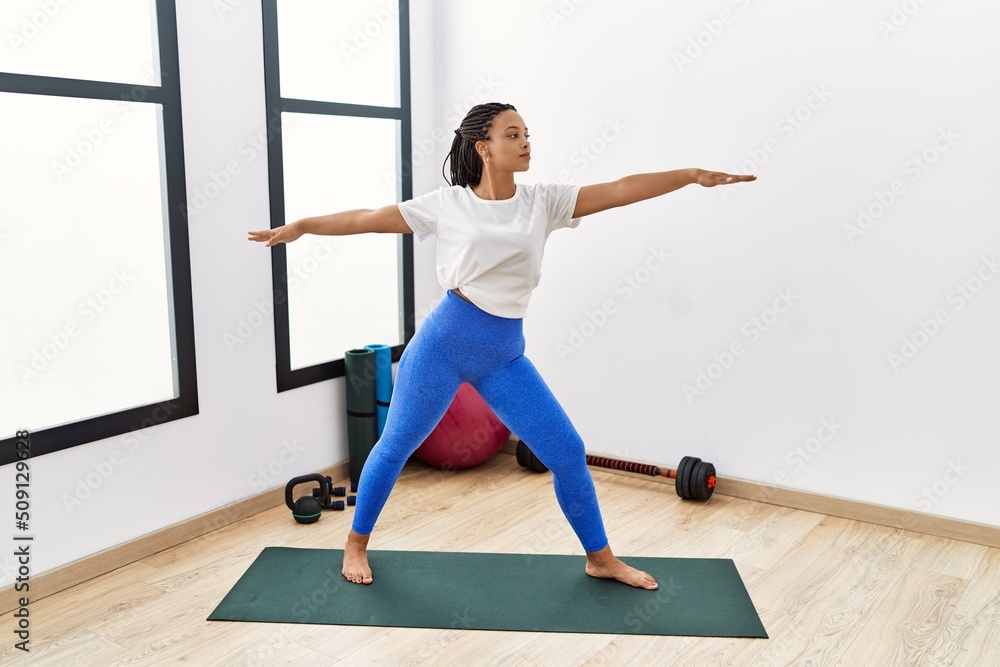 Young african american woman training yoga at sport center Young african american woman training yoga at sport center