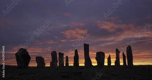 4k cloud and light movement over Callanish Stones at sunrise. Stones in silhouette. No people. Famous prehistoric standing stones, Isle of Lewis, Outer Hebrides, Scotland