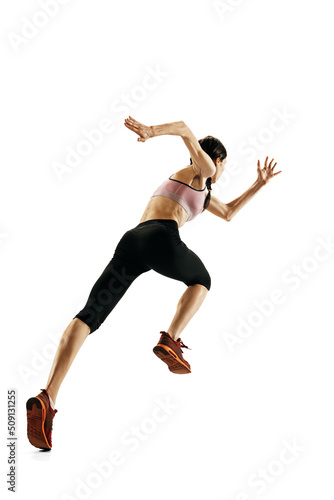 Young caucasian woman running isolated on white studio background. One female runner or jogger. Sport, track-and-field athletics, competition concept © master1305