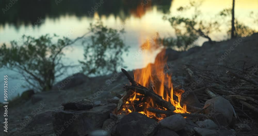 Campfire at a big river in beautiful evening mood Campfire at a big river in beautiful evening mood