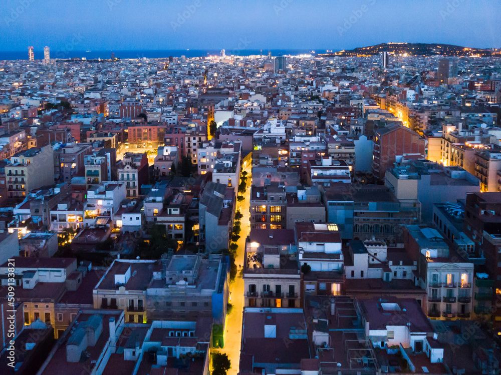 mass of roofs of houses on the spanish city of Barcelona in the evening