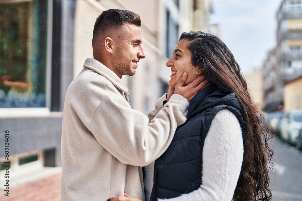 Man and woman couple smiling confident standing together at street Man and woman couple smiling confident standing together at street