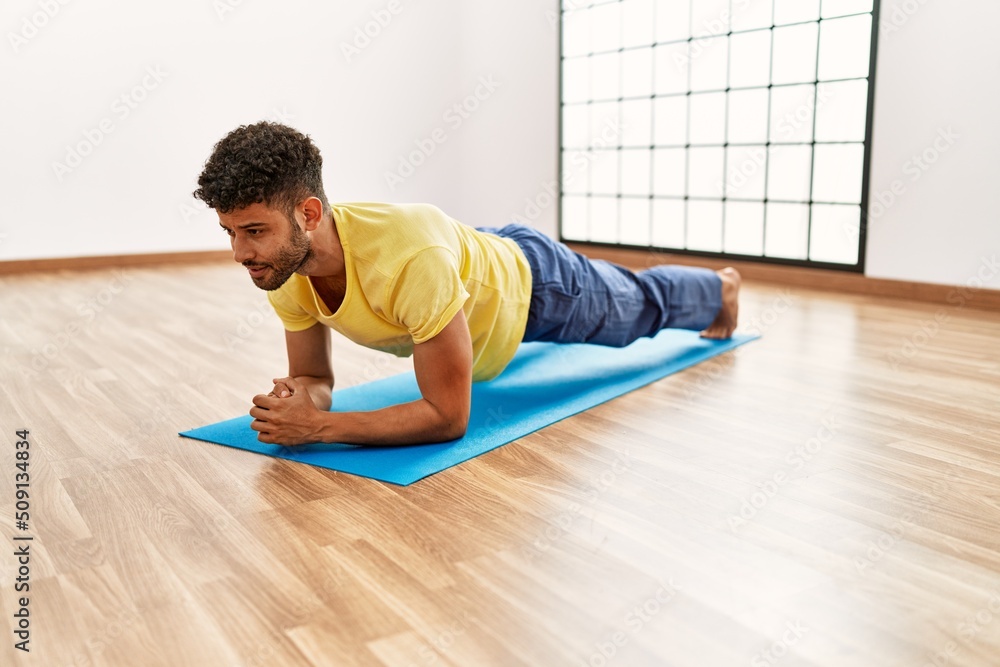Young arab sporty man concentrate training abs exercise at sport center. Young arab sporty man concentrate training abs exercise at sport center.