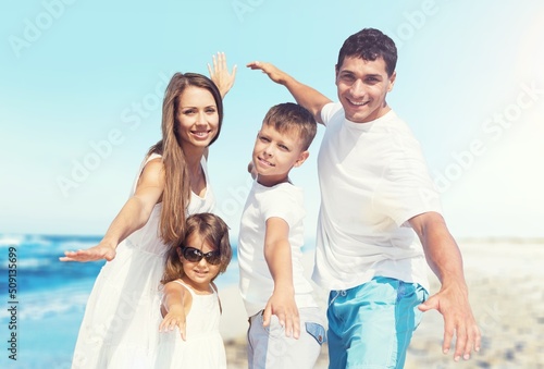 Happy family having fun on the beach. Mother and father. Summer vacation concept © BillionPhotos.com