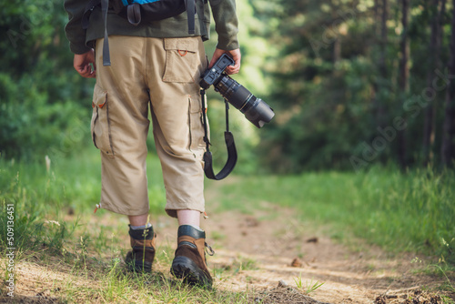 Image of man photographing while hiking in the nature.