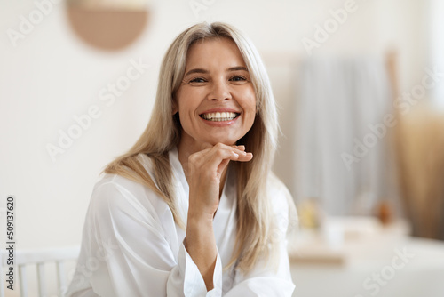 Fotografija Happy blonde woman posing at white bathroom at home