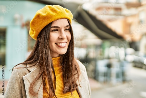 Young hispanic girl smiling happy standing at the city.