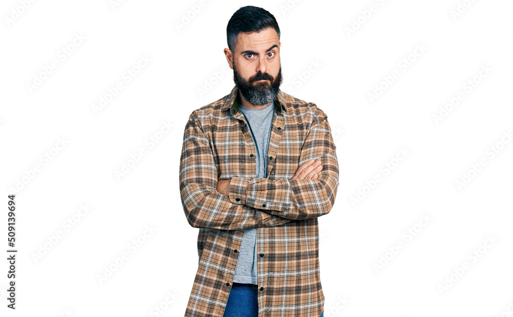 Hispanic man with beard with arms crossed gesture skeptic and nervous, frowning upset because of problem. negative person. Hispanic man with beard with arms crossed gesture skeptic and nervous, frowning upset because of problem. negative person.