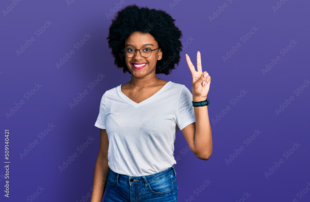 Young african american woman wearing casual white t shirt showing and pointing up with fingers number two while smiling confident and happy. Young african american woman wearing casual white t shirt showing and pointing up with fingers number two while smiling confident and happy.