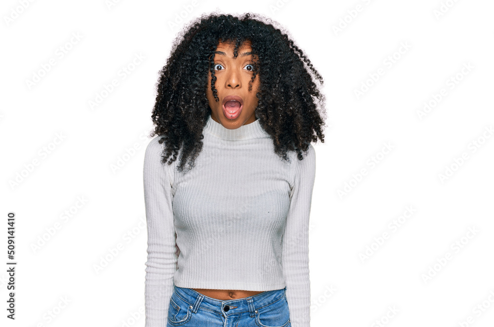 Young african american girl wearing casual clothes afraid and shocked with surprise and amazed expression, fear and excited face. Young african american girl wearing casual clothes afraid and shocked with surprise and amazed expression, fear and excited face.