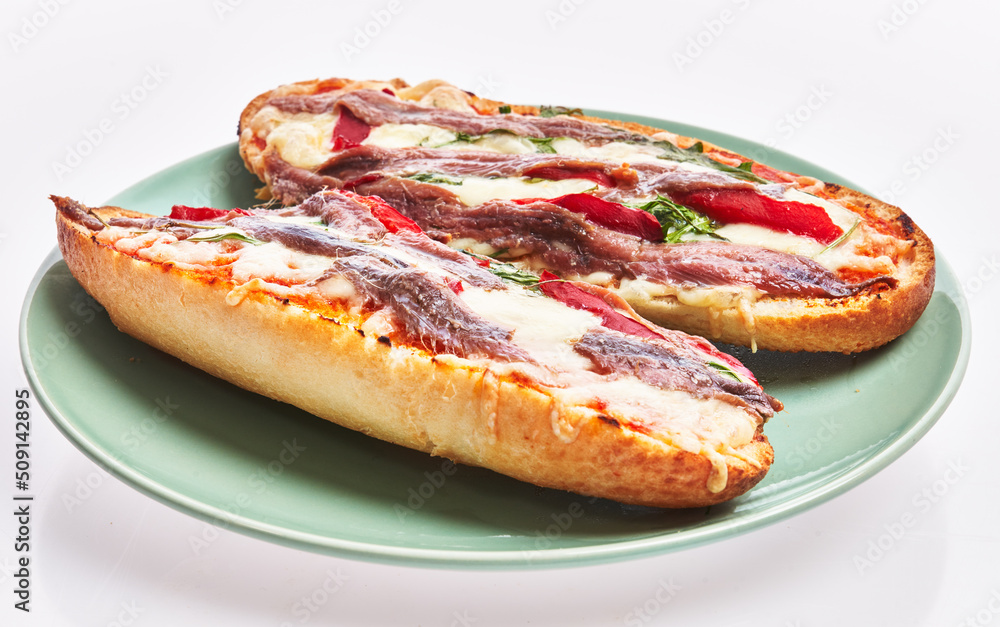 Plate of anchovies bread pizzas over white isolated background Plate of anchovies bread pizzas over white isolated background