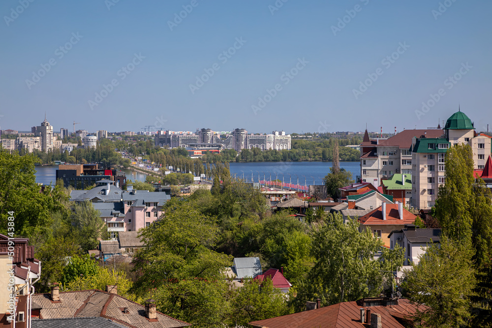 Beautiful view of the city from the observation deck. Little houses. River in the distance. Sunny day. Urban architecture.