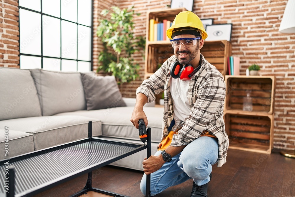 Young hispanic man worker smiling confident repairing table at home Young hispanic man worker smiling confident repairing table at home