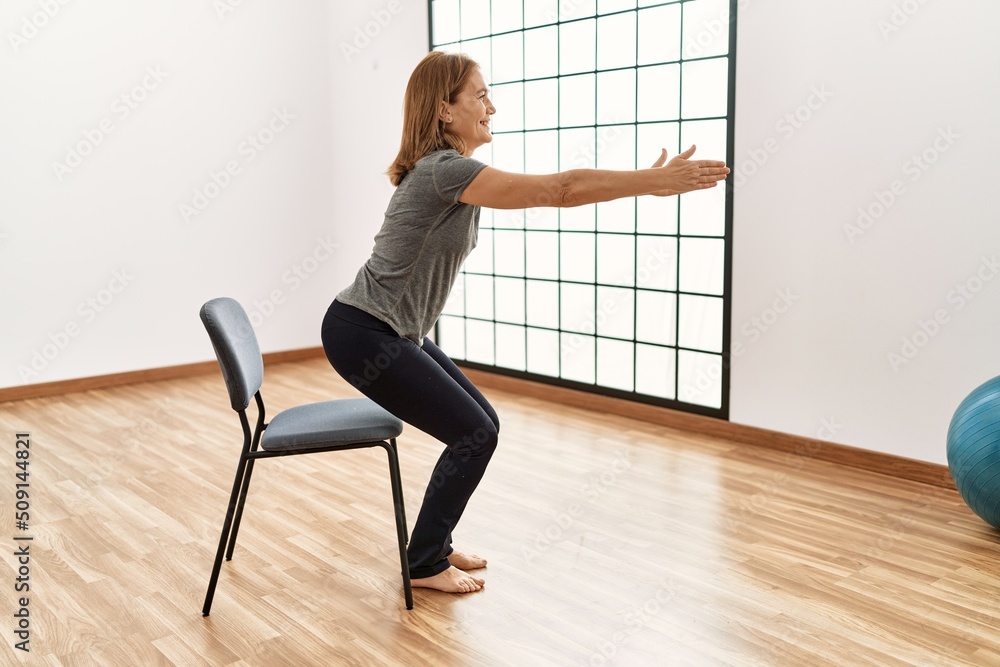 Middle age caucasian woman smiling confident training at sport center Middle age caucasian woman smiling confident training at sport center