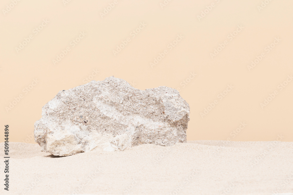 Grungy grey concrete stone platform podium for cosmetics or products on white beach sand background. Front view Grungy grey concrete stone platform podium for cosmetics or products on white beach sand background. Front view