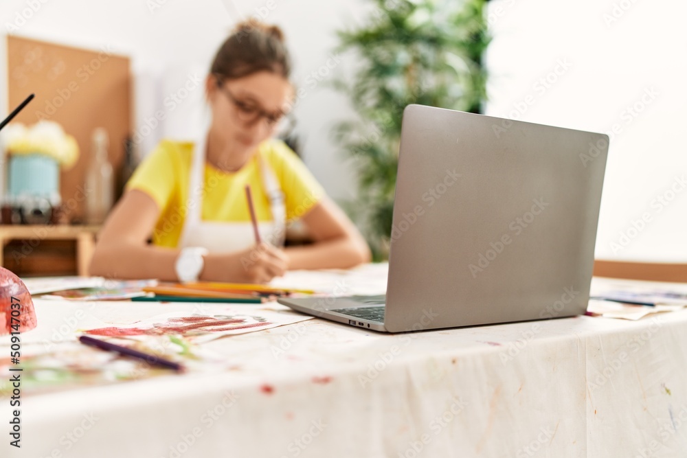 Adorable girl smiling confident having online draw lesson at art studio Adorable girl smiling confident having online draw lesson at art studio