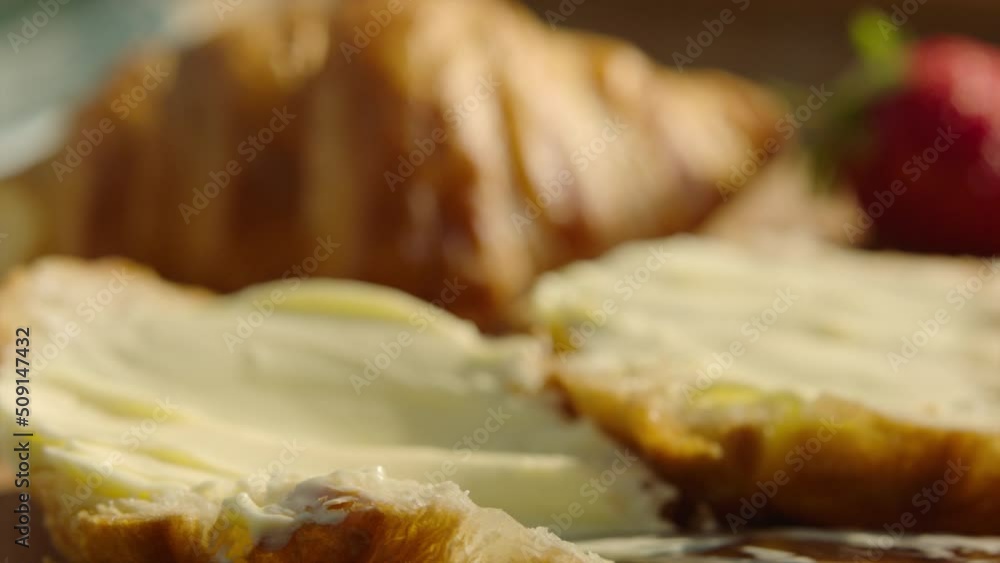 Close up buttering croissant fresh baked Close up buttering croissant fresh baked