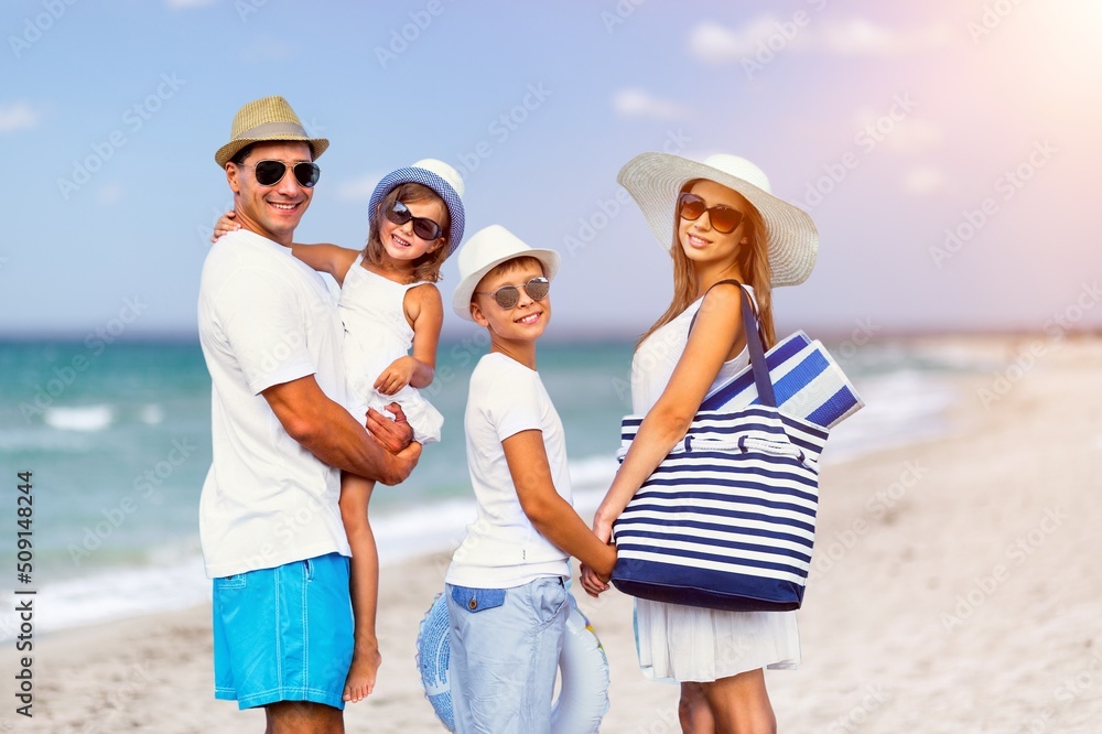 Happy family having fun on the beach. Mother and father. Summer vacation concept Happy family having fun on the beach. Mother and father. Summer vacation concept