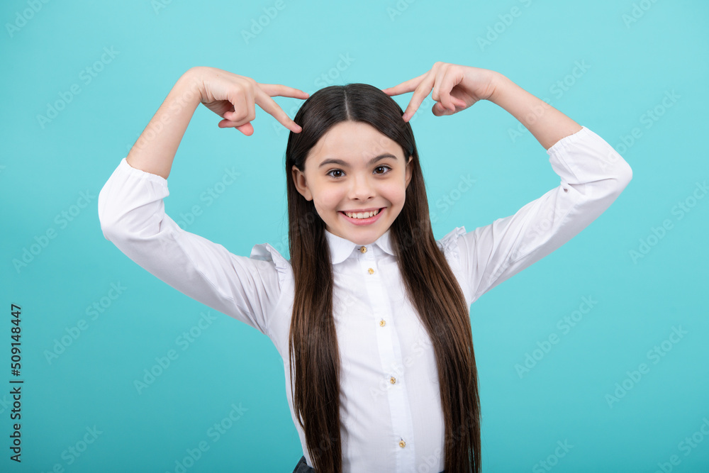 Fototapeta premium Children studio portrait on blue background. Childhood lifestyle concept. Funny teenage girl face close up.