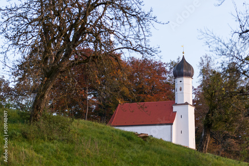 a white church on the bavarian countryside in the evening