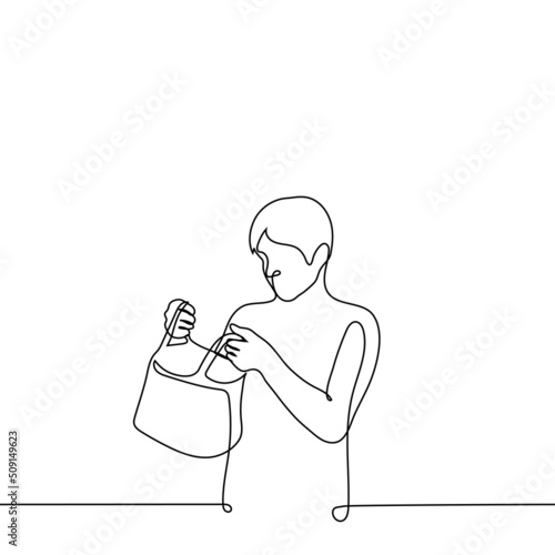 man holding an open bag or package and looking inside - one line drawing vector. the concept of receiving a gift, checking in someone else's bag