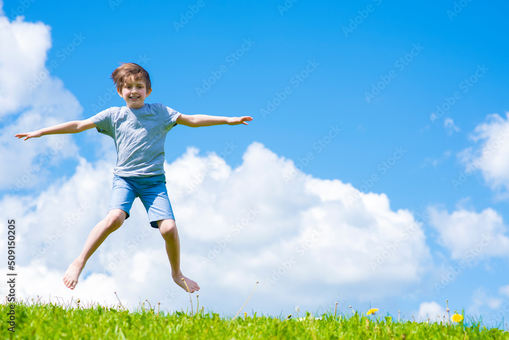 portrait of happy jumping boy in summer portrait of happy jumping boy in summer